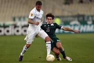 Lazaros Christodoulopoulos (R) of Panathinaikos tackles Tottenham's Kyle Walker